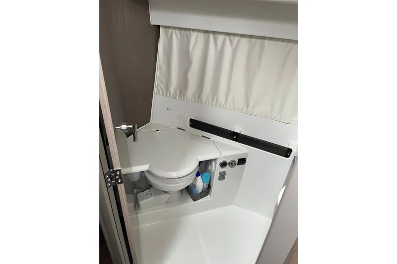 Slide: The Image of 2025 Jeanneau NC 895 Sport Series 2 boat bathroom interior with compact toilet. - 22