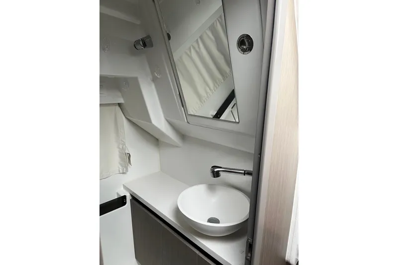 Slide: The Image of 2025 Jeanneau NC 895 Sport Series 2 bathroom with modern sink and mirror. - 23
