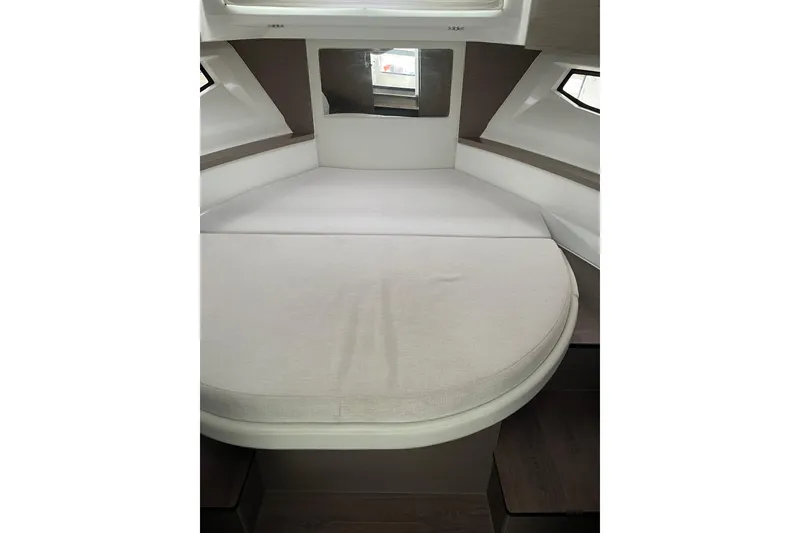 Slide: The Image of 2025 Jeanneau NC 895 Sport Series 2 cabin interior with bed and windows. - 26