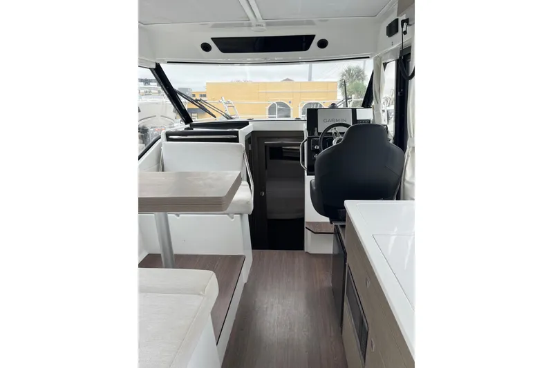 Slide: The Image of Interior of 2025 Jeanneau NC 895 Sport Series 2 boat, featuring helm and seating area. - 30