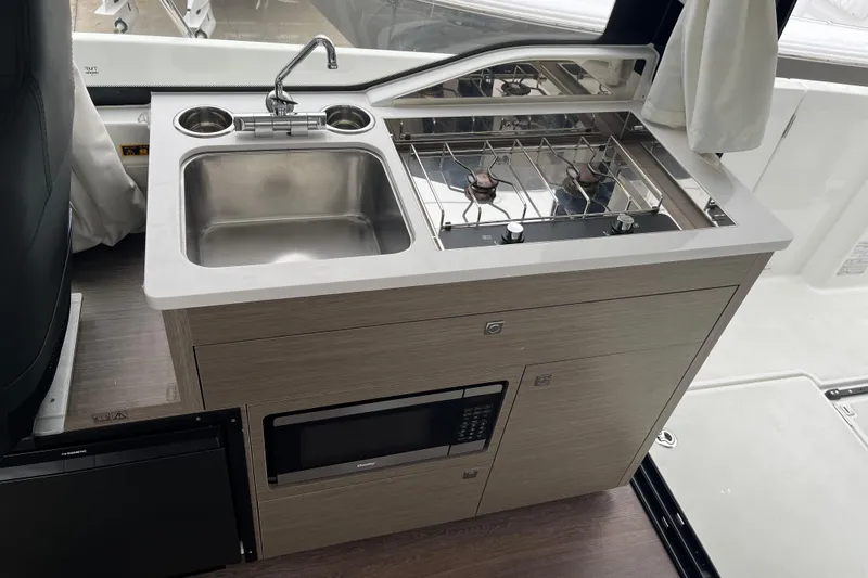 Slide: The Image of Compact kitchen area in the 2025 Jeanneau NC 895 Sport Series 2 boat. - 33