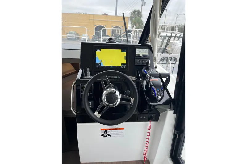 Slide: The Image of 2025 Jeanneau NC 895 Sport Series 2 helm with navigation display and controls. - 35