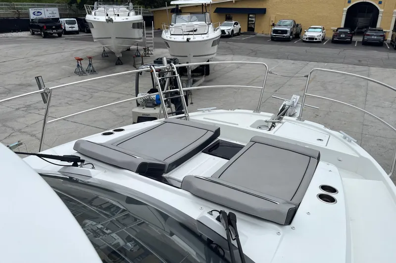 Slide: The Image of 2025 Jeanneau NC 895 Sport Series 2 boat with sun pads, docked in a marina. - 38