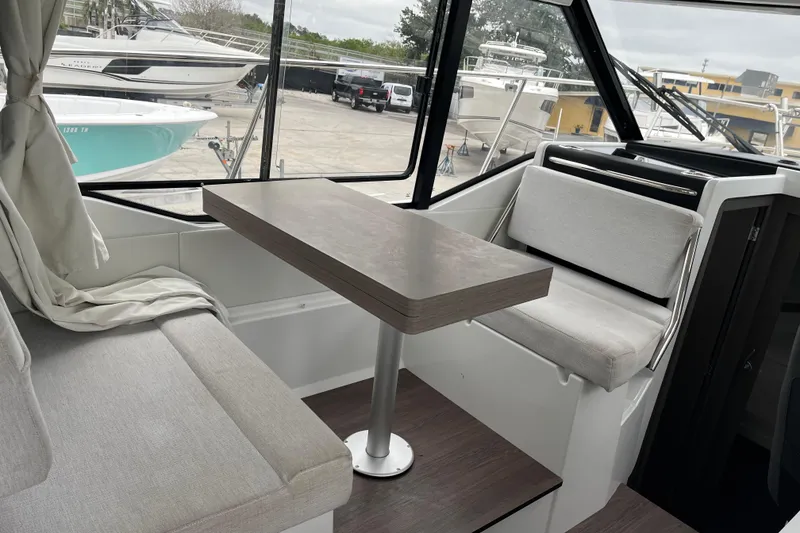 Slide: The Image of Interior of 2025 Jeanneau NC 895 Sport Series 2, featuring seating and table. - 6