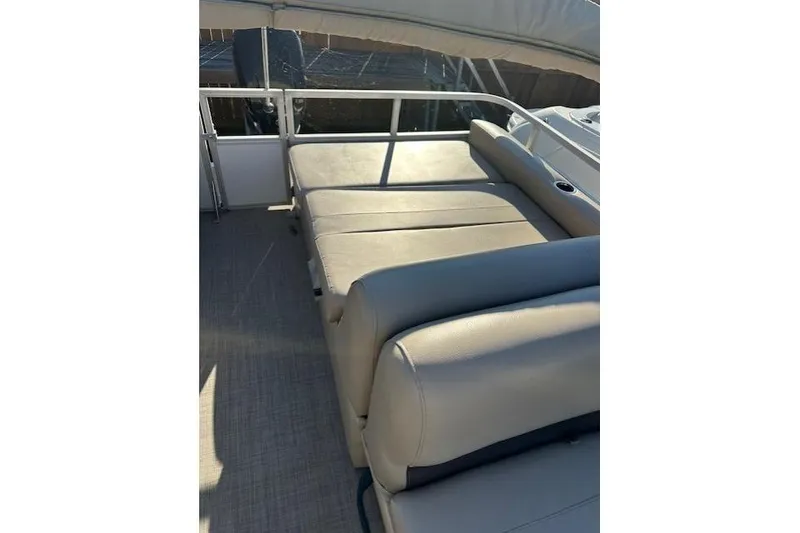 Slide: The Image of 2017 Sun Tracker Party Barge 22 DLX interior seating area with beige upholstery. - 10