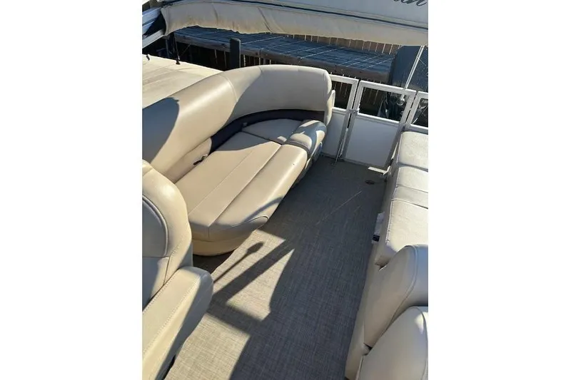 Slide: The Image of 2017 Sun Tracker Party Barge 22 DLX with beige seating and spacious deck area. - 11