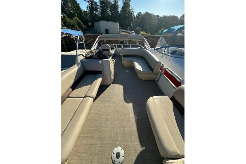 Slide: The Image of 2017 Sun Tracker Party Barge 22 DLX with spacious seating and canopy, docked outdoors. - 13