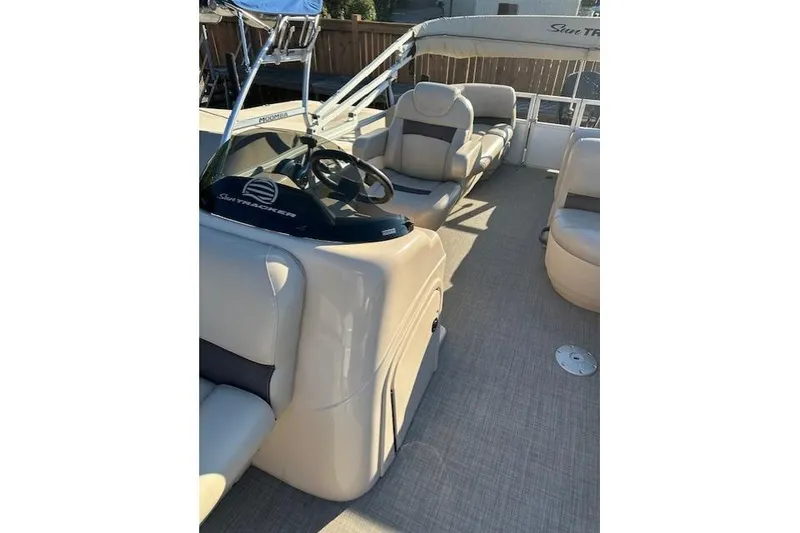 Slide: The Image of 2017 Sun Tracker Party Barge 22 DLX interior with helm and seating. - 14