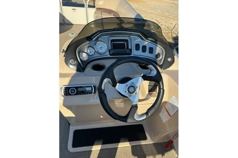 Slide: The Image of 2017 Sun Tracker Party Barge 22 DLX steering console with gauges and controls. - 16