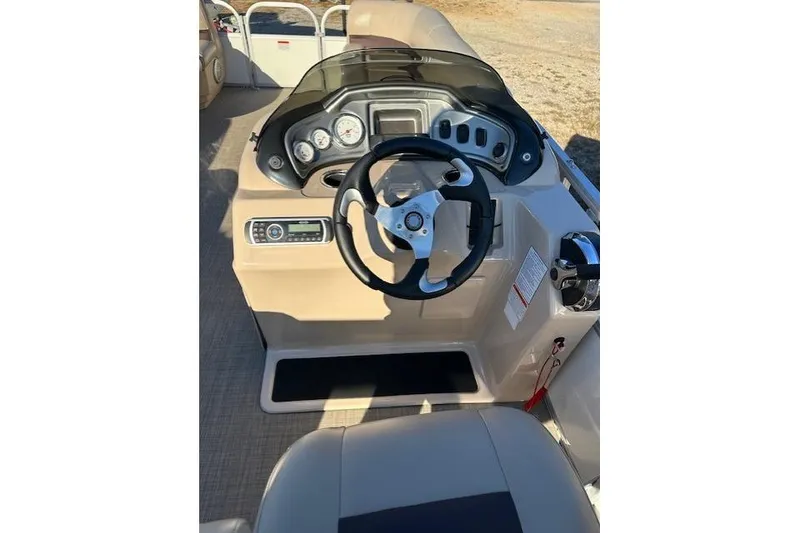 Slide: The Image of 2017 Sun Tracker Party Barge 22 DLX helm with steering wheel and control panel. - 17