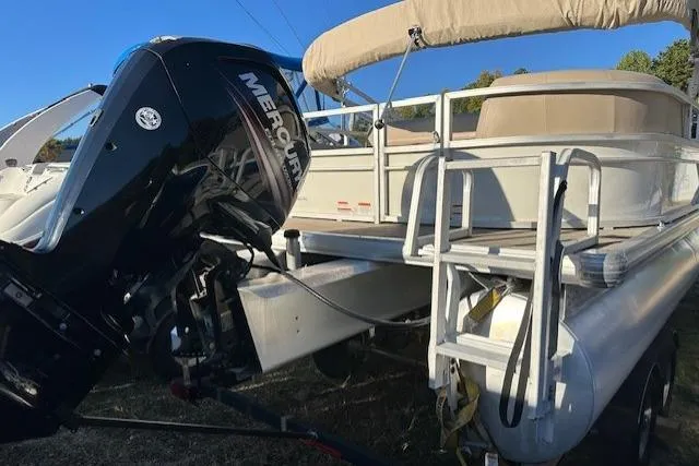 Slide: The Image of 2017 Sun Tracker Party Barge 22 DLX with Mercury outboard engine, docked on grass. - 6
