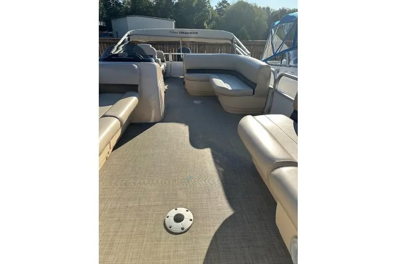 Slide: The Image of 2017 Sun Tracker Party Barge 22 DLX interior with spacious seating and open deck. - 9