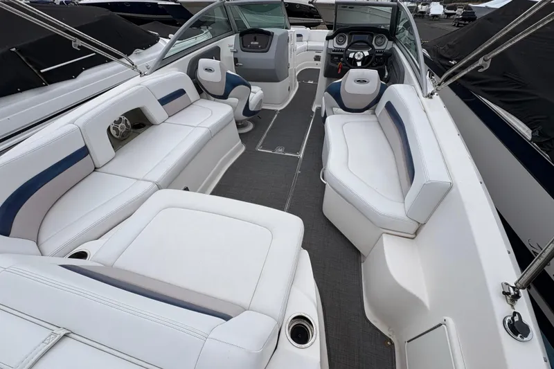 Slide: The Image of 2015 Chaparral 264 Sunesta boat interior with white seating and modern dashboard. - 10