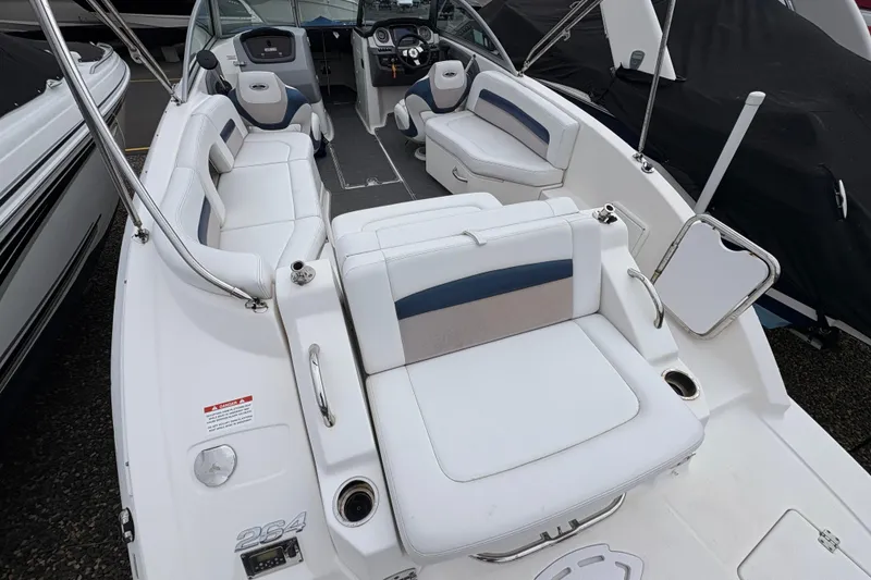 Slide: The Image of 2015 Chaparral 264 Sunesta boat interior with white seating and modern dashboard. - 11