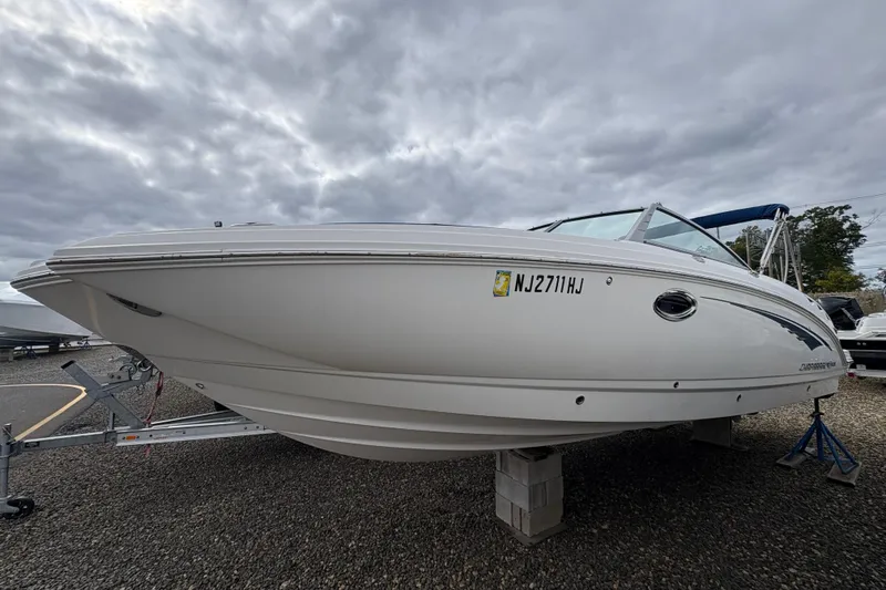 Slide: The Image of 2015 Chaparral 264 Sunesta boat on trailer under cloudy sky. - 3