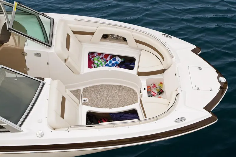 Slide: The Image of 2015 Chaparral 264 Sunesta boat interior with white cushioned seating and gray flooring. - 5