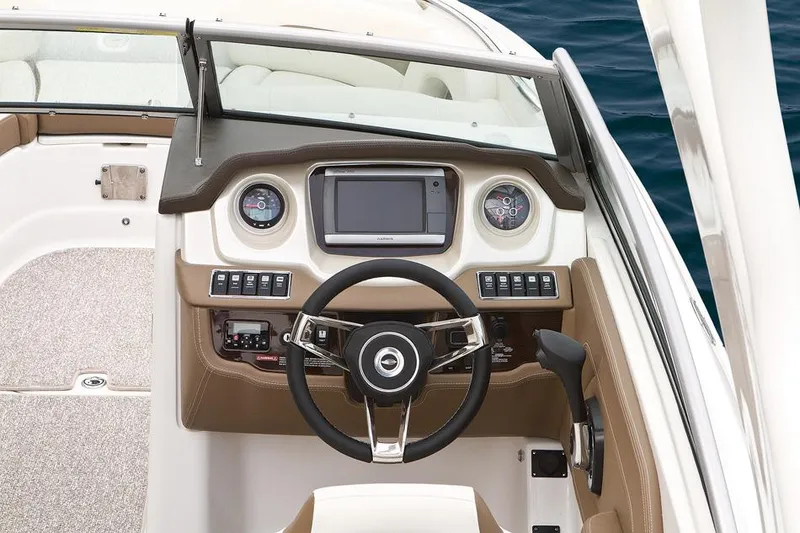 Slide: The Image of 2015 Chaparral 264 Sunesta boat dashboard with steering wheel and control panel. - 6