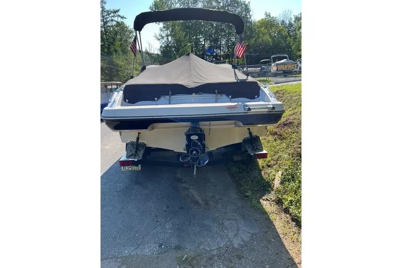 The Image of 2012 Crownline 215 SS boat, rear view with cover, parked outdoors. - 1