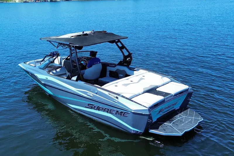 Slide: The Image of 2021 Supreme ZS232 boat on calm blue water, featuring sleek design and spacious seating. - 1