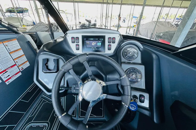 Slide: The Image of 2021 Supreme ZS232 boat dashboard with steering wheel and control panel. - 15