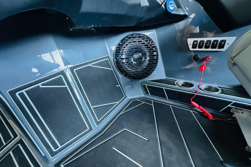 Slide: The Image of 2021 Supreme ZS232 boat interior with speaker, control panel, and cup holders. - 16
