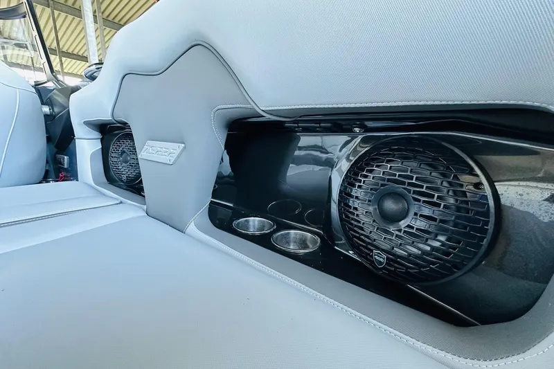 Slide: The Image of 2021 Supreme ZS232 boat interior with speakers and cup holders. - 17