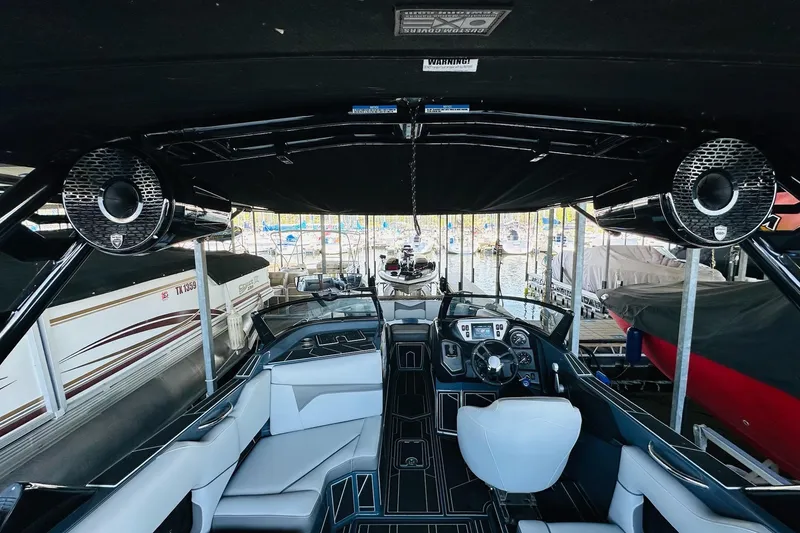 Slide: The Image of 2021 Supreme ZS232 boat interior with sleek seating and advanced dashboard controls. - 18