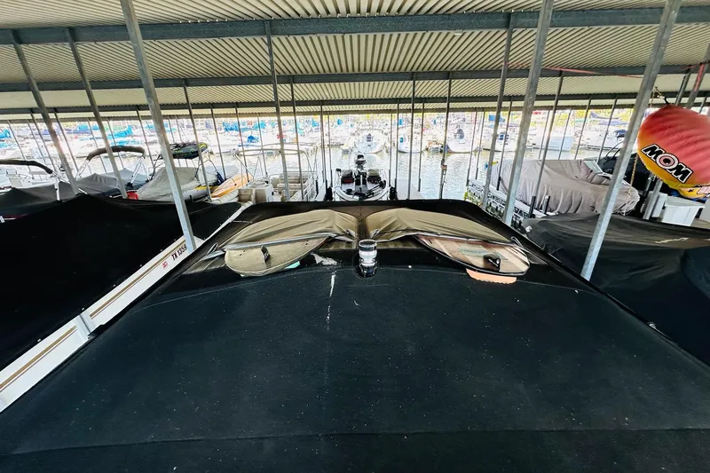 Slide: The Image of 2021 Supreme ZS232 boat docked under covered marina with other boats. - 20