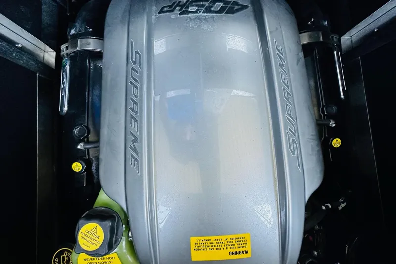 Slide: The Image of 2021 Supreme ZS232 engine compartment with visible branding and caution labels. - 22