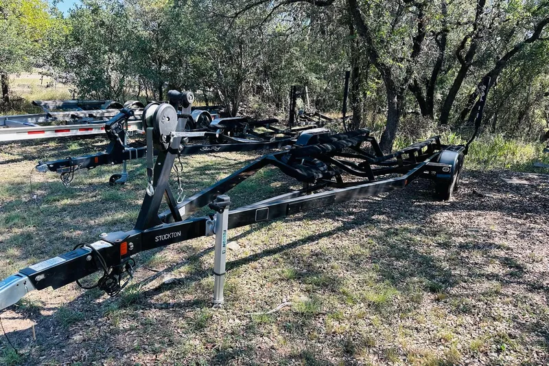 Slide: The Image of 2021 Supreme ZS232 boat trailer in a wooded area, featuring sturdy construction. - 23