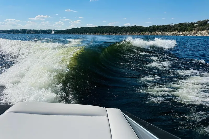 Slide: The Image of 2021 Supreme ZS232 boat creating waves on a sunny lake. - 24