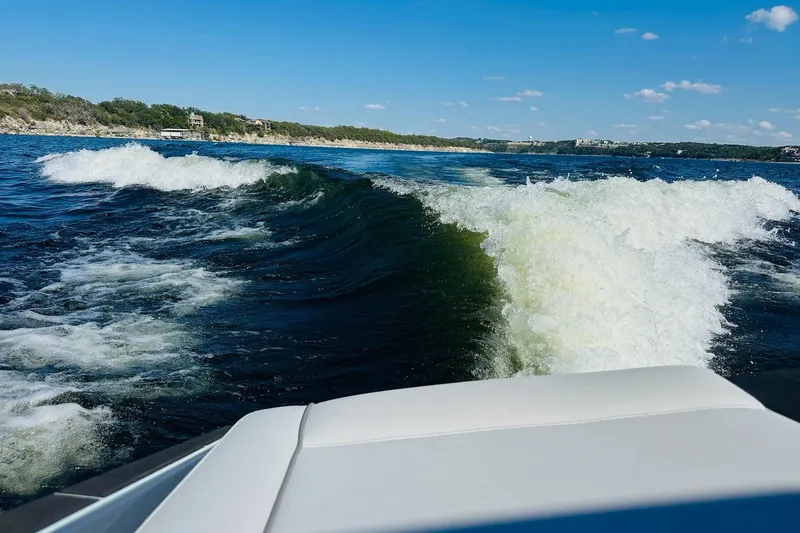 Slide: The Image of 2021 Supreme ZS232 boat creating waves on a sunny lake. - 25