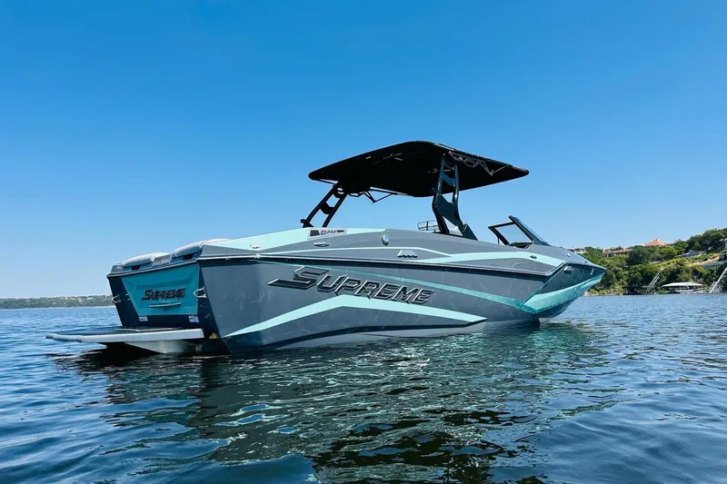 Slide: The Image of 2021 Supreme ZS232 boat on calm water under clear blue sky. - 4