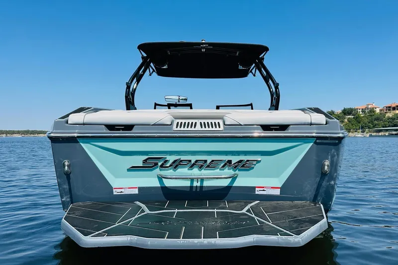 Slide: The Image of 2021 Supreme ZS232 boat on water, rear view with clear blue sky. - 5