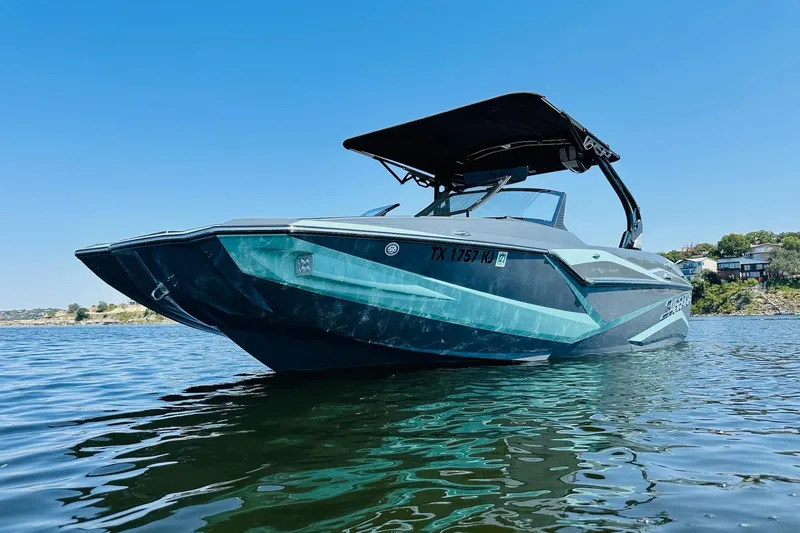 Slide: The Image of 2021 Supreme ZS232 boat on water, sleek design, sunny day, clear blue sky. - 6