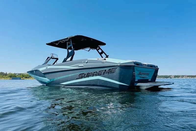 Slide: The Image of 2021 Supreme ZS232 boat on calm water under clear blue sky. - 7