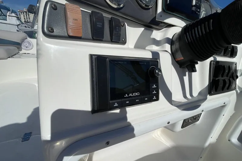 Slide: The Image of Control panel of a 2017 Hurricane SunDeck Sport 202 OB boat with JL Audio system. - 16