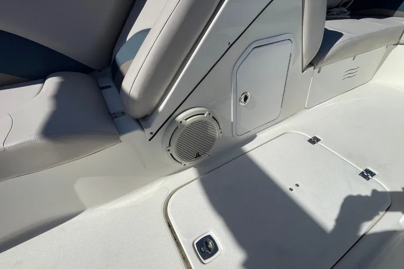 Slide: The Image of 2017 Hurricane SunDeck Sport 202 OB interior with seating and speaker detail. - 20