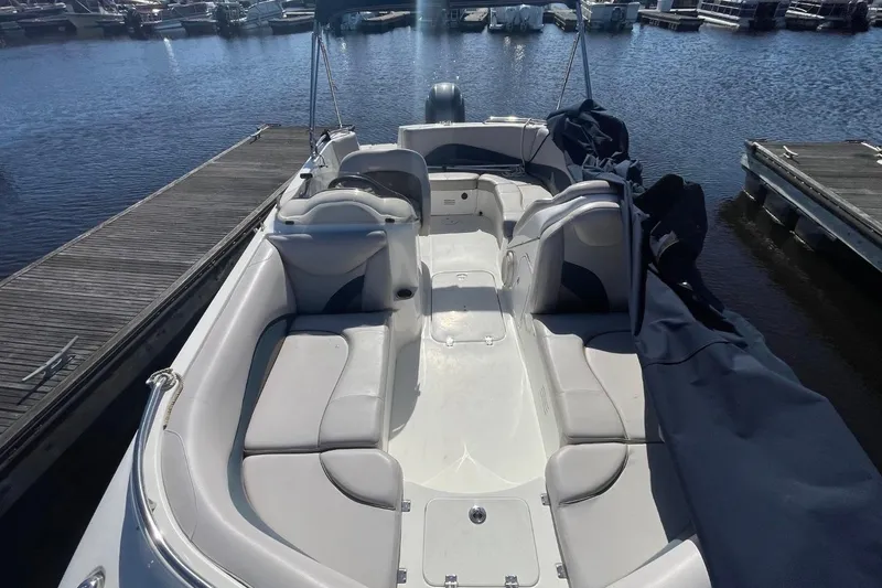 Slide: The Image of 2017 Hurricane SunDeck Sport 202 OB boat docked, featuring spacious seating and sleek design. - 21