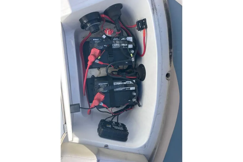 Slide: The Image of 2017 Hurricane SunDeck Sport 202 OB boat battery compartment with wiring and components. - 22