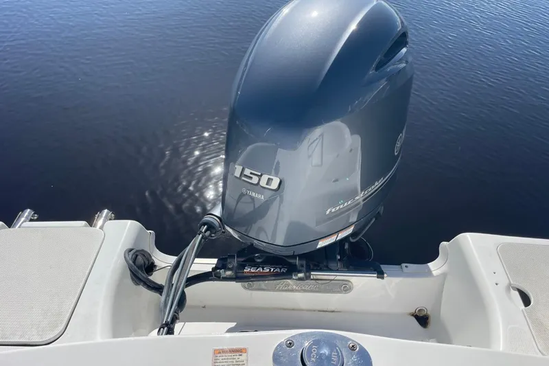 Slide: The Image of 2017 Hurricane SunDeck Sport 202 OB with Yamaha 150 outboard motor on calm water. - 25