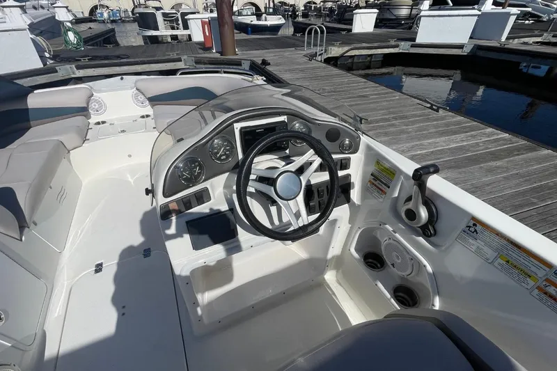 Slide: The Image of 2017 Hurricane SunDeck Sport 202 OB boat interior with steering wheel and seating. - 3