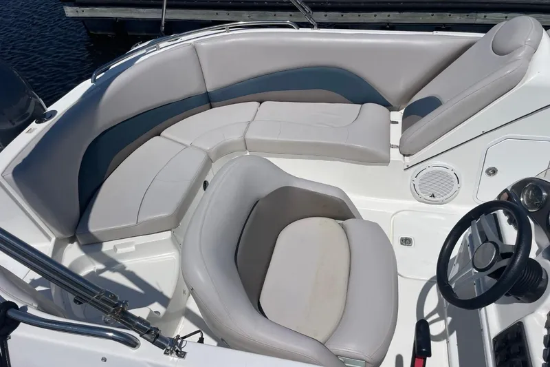 Slide: The Image of 2017 Hurricane SunDeck Sport 202 OB boat interior with cushioned seating and steering wheel. - 33