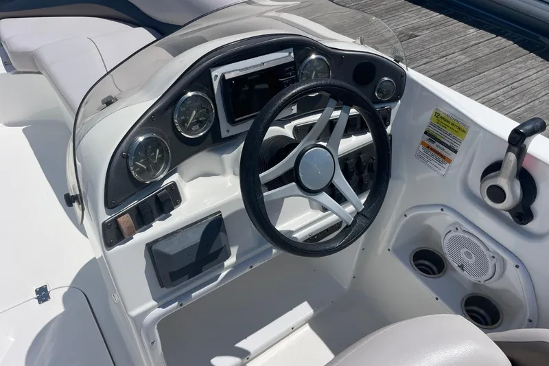 Slide: The Image of 2017 Hurricane SunDeck Sport 202 OB boat dashboard with steering wheel and controls. - 35