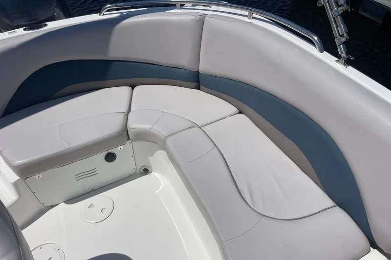 Slide: The Image of 2017 Hurricane SunDeck Sport 202 OB boat interior seating, featuring gray and blue cushioned seats. - 36