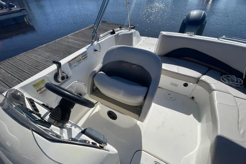 Slide: The Image of 2017 Hurricane SunDeck Sport 202 OB boat interior with steering wheel and seating. - 4