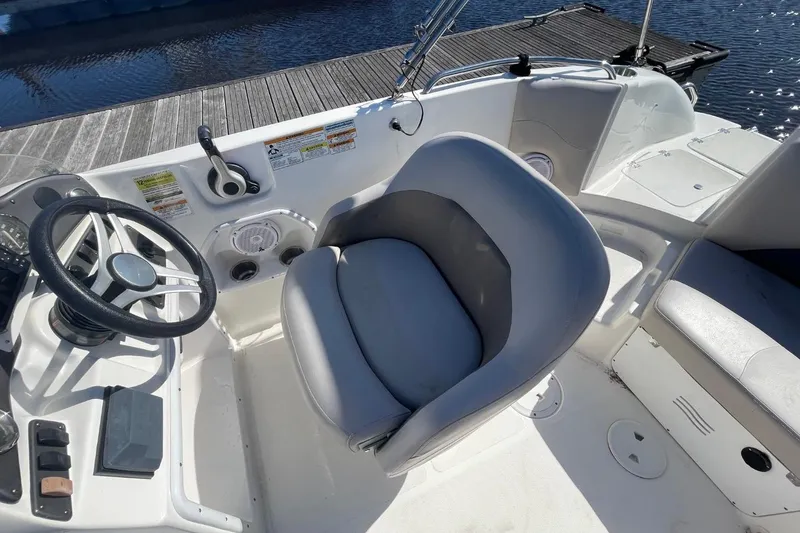 Slide: The Image of 2017 Hurricane SunDeck Sport 202 OB boat cockpit with steering wheel and seating. - 5