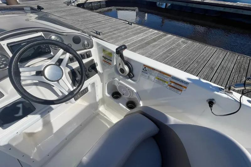 Slide: The Image of 2017 Hurricane SunDeck Sport 202 OB boat interior with steering wheel and controls. - 8
