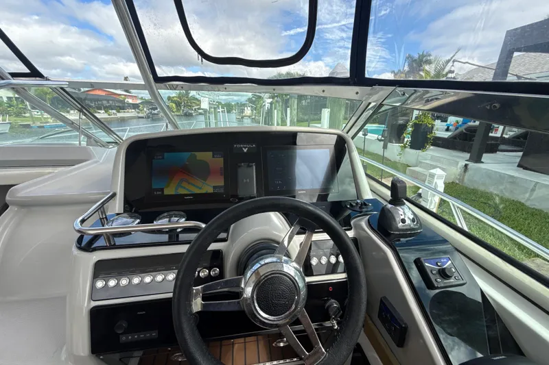 Slide: The Image of 2009 Formula 40 Performance Cruiser cockpit with leather seating and modern dashboard. - 14