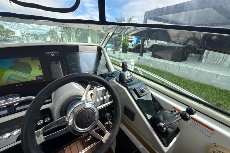 Slide: The Image of 2009 Formula 40 Performance Cruiser helm with modern navigation displays and controls. - 15